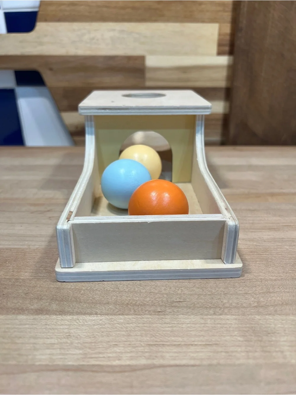 Wooden Ball Drop Toy with Orange, Blue, and Yellow Balls